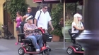 Hugh Hefner and Wife Ride Around Disneyland with Scooters